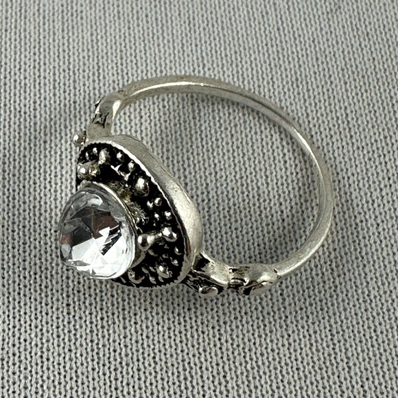 Silver tone ring with a clear teardrop shaped crystal center. - Picture 2 of 4